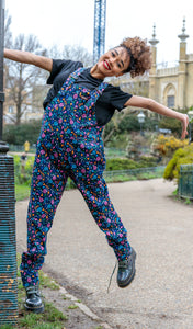 model wearing navy dungarees swinging from lampost