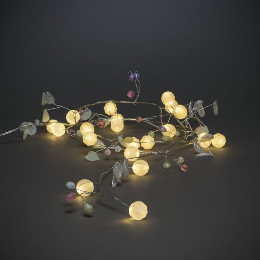 Warm white light with coloured berries and leaves string lights.  Battery operated.  3 x AA batteries. (not included)